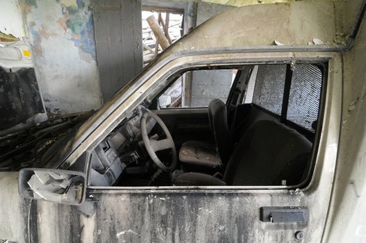 Old destroyed car abandoned in a farm in north Italy