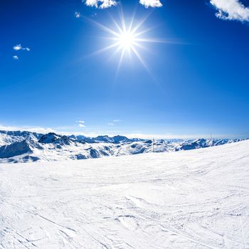 Winter mountain landscape with sun