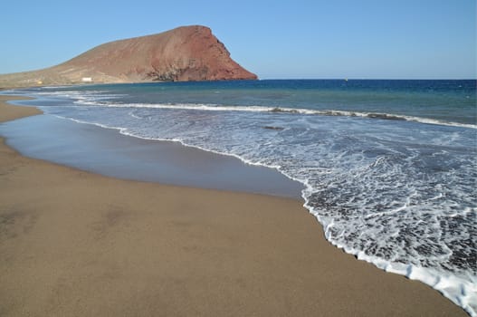 Red mountain over the Atlantic ocean,in Tenerife, Spain