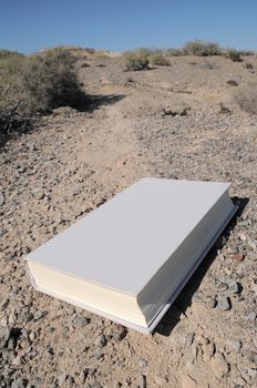 Empty Book on a road in the desert 