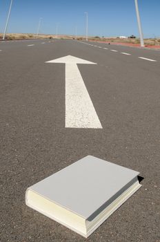 arrow on a asphalt street to the future