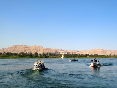 Egyptian boats with tourists on the river Nile near Luxor, Egypt, Africa.