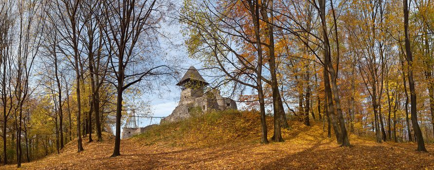 Panorama of old castle in autumn forest