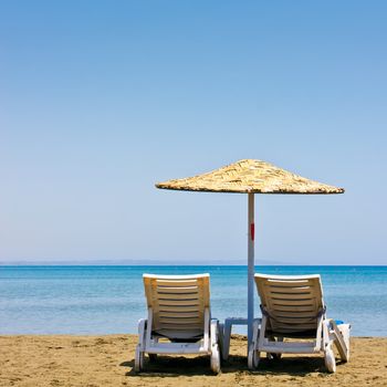 Two old beach chairs and umbrella