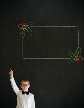 Hand up answer boy dressed up as business man with Christmas holly to do checklist on blackboard background