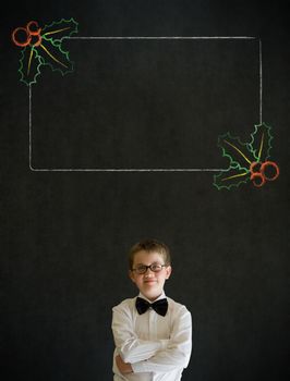 Thinking boy dressed up as business man with Christmas holly to do checklist on blackboard background