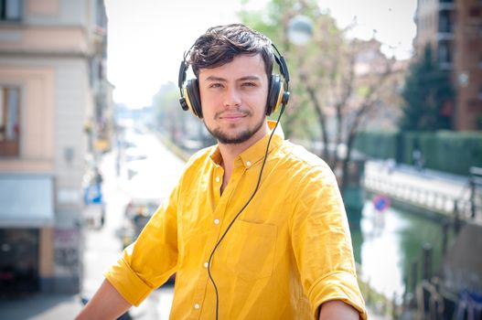hipster young man listening to music on the balcony 