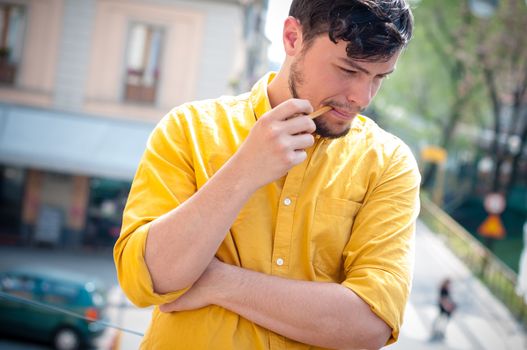 young man smoking pipe on the balcony