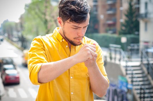 young man smoking pipe on the balcony