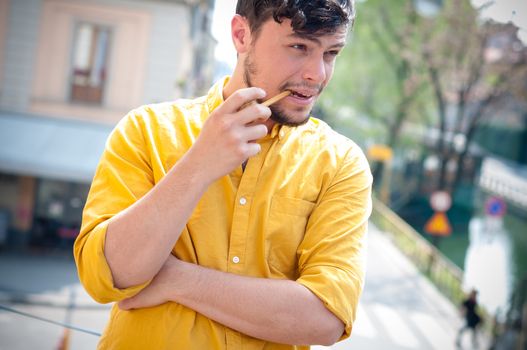 young man smoking pipe on the balcony