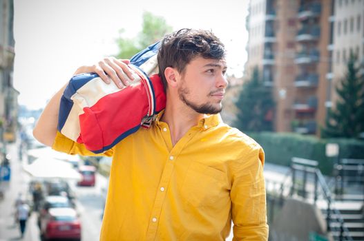 hipster young man with bag in the city