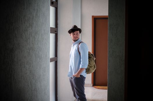 hipster young man posing in a hallway
