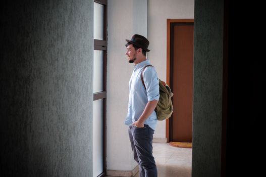 hipster young man posing in a hallway