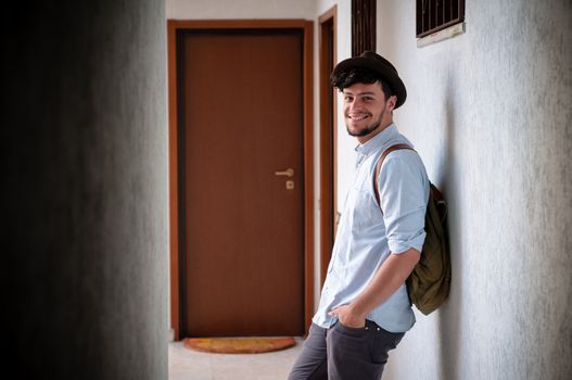 hipster young man posing in a hallway