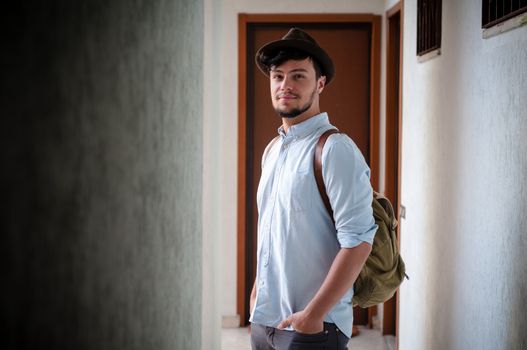 hipster young man posing in a hallway