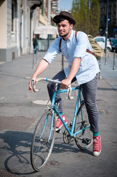 hipster young man on bike in the city