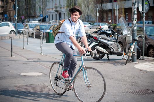 hipster young man on bike in the city