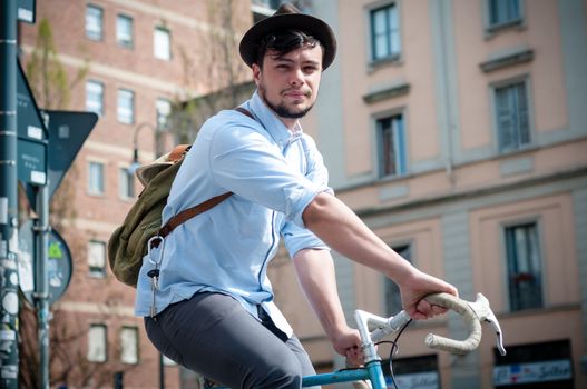 hipster young man on bike in the city