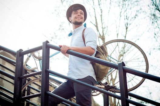 hipster young man on bike in the city