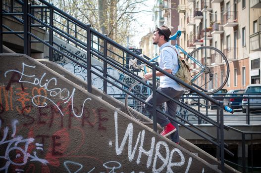 hipster young man on bike in the city