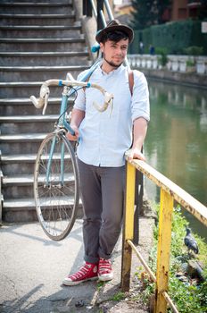 hipster young man on bike in the city