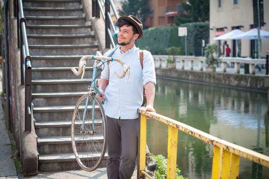 hipster young man on bike in the city