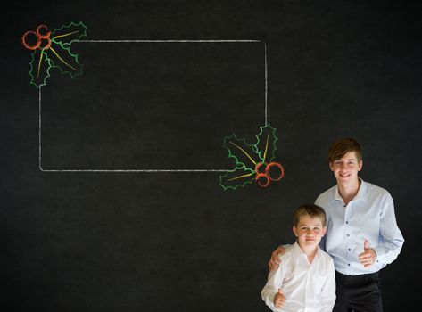Thumbs up boy dressed up as business man with teacher man and Christmas holly to do checklist on blackboard background