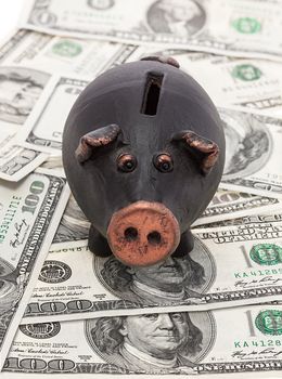 Money and black piggy bank
