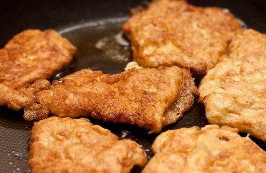 Chicken chops preparing on griddle