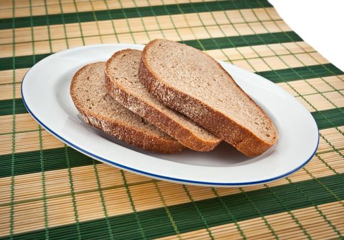 Three slices of brown bread on a plate