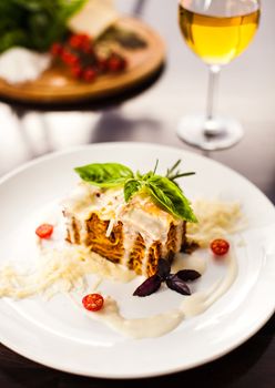 Lasagna with basil and cherry tomatoes. Small DOF