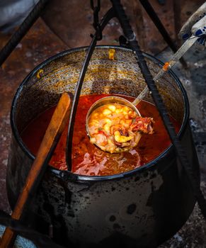 Traditional appetizing and tasty hungarian goulash soup in cauldron