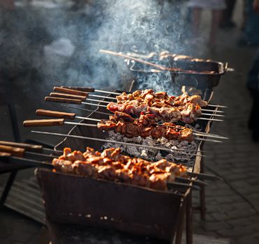Delicious shish kebab grills on the barbecue in smoke