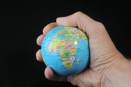 Globe in an  hand on a black background