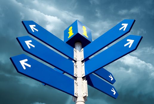 Blank directional road signs over cloudy sky