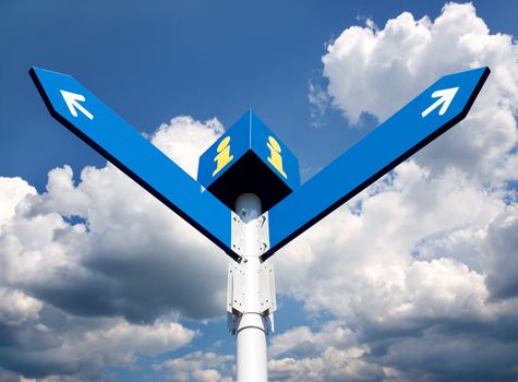 Blank directional road signs over blue sky