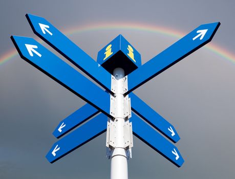 Blank directional road signs on rainbow background