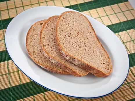 Three slices of brown bread on a plate