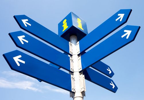 Blank directional road signs over blue sky