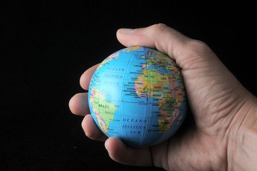 Globe in an  hand on a black background