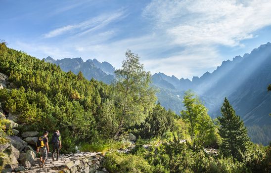 Tourists on mountain trail in High Tatra Mountains. Slovakia. Europe.