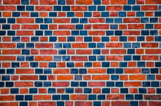 Decorative ornament made ������by red and black bricks on wall of an old house