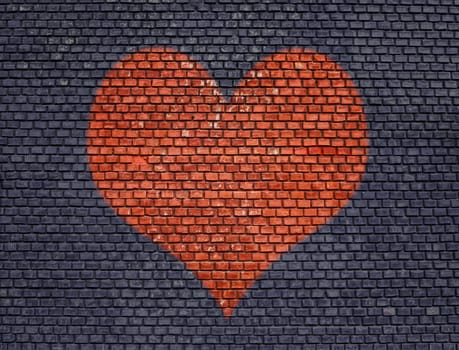 Painted red big heart on old brick wall