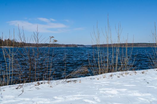 Snowy shore of Glienicke lake on Havel river in Germany