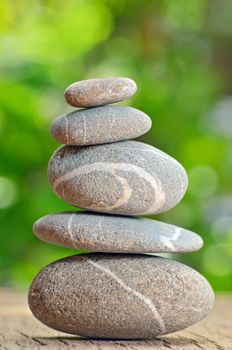 Stacked stones on a green natural background
