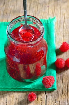 Homemade Raspberry Jam against a wooden background