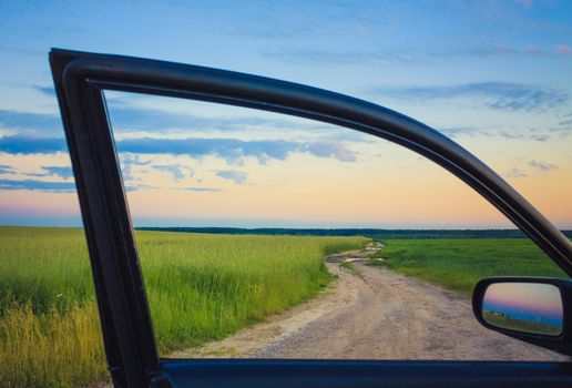 Dirty Rural Road In Countryside. View On Car Window