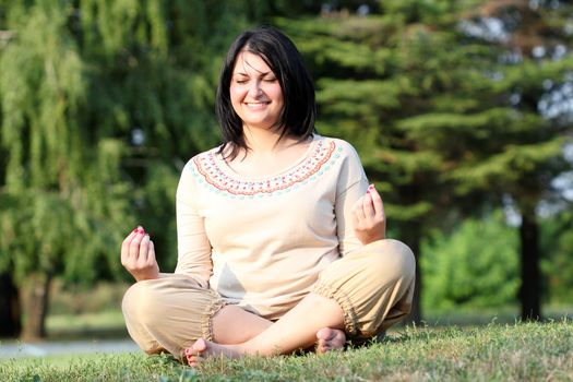 beautiful girl meditating in park