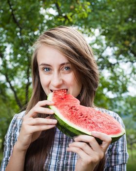 Young woman with watermelon outdoors