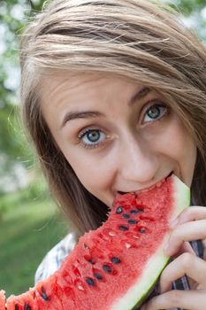 Young woman with watermelon outdoors